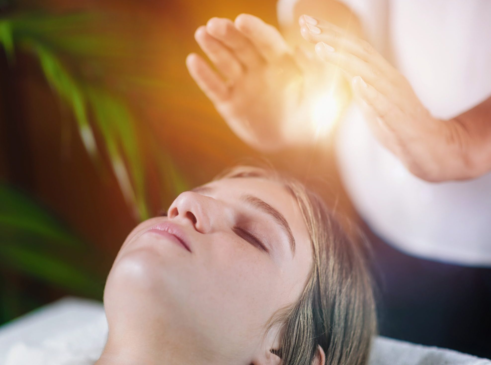 Close Up Of A Relaxed Young Woman Having Reiki Healing Treatment
